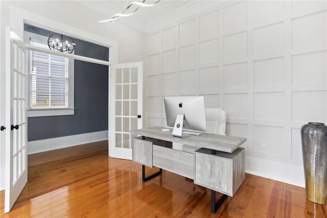 736 Belleville St, New Orleans, LA 70114 - unfurnished office with a decorative wall, french doors, a chandelier, and wood finished floors
