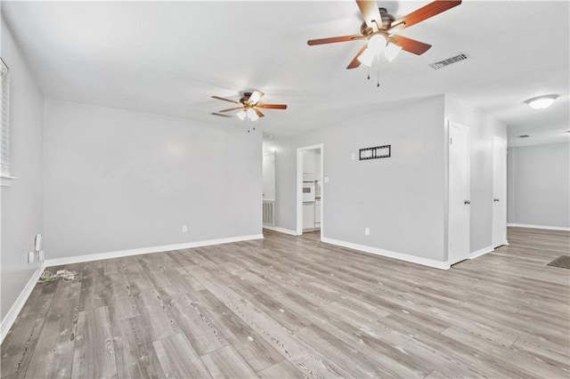 1558 Monaco Dr, Slidell, LA 70458 - unfurnished living room featuring a ceiling fan, light wood-style flooring, and baseboards