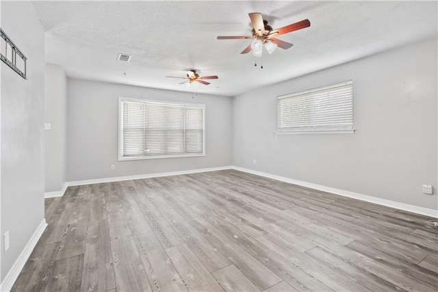1558 Monaco Dr, Slidell, LA 70458 - spare room featuring wood finished floors, healthy amount of natural light, ceiling fan, and a textured ceiling