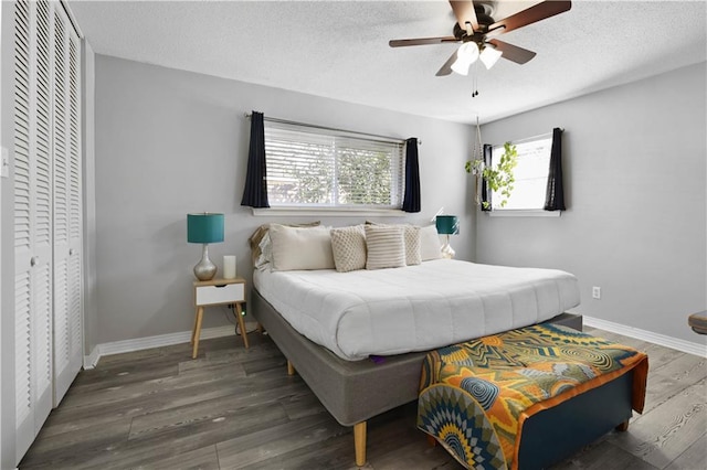 bedroom with baseboards, a textured ceiling, and wood finished floors