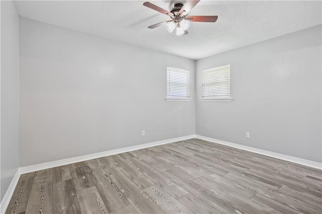 1558 Monaco Dr, Slidell, LA 70458 - unfurnished room featuring ceiling fan, wood finished floors, a textured ceiling, and baseboards