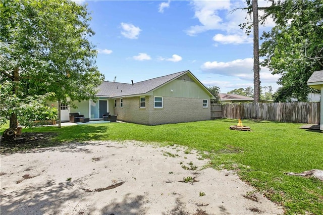 1558 Monaco Dr, Slidell, LA 70458 - rear view of property with an outdoor fire pit and a patio
