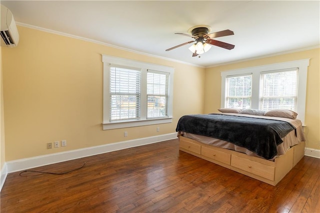 bedroom featuring multiple windows, ornamental molding, an AC wall unit, and hardwood / wood-style flooring