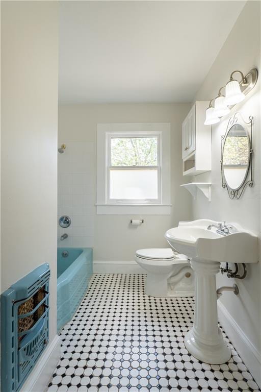 full bath featuring tile patterned flooring, baseboards, toilet, heating unit, and washtub / shower combination