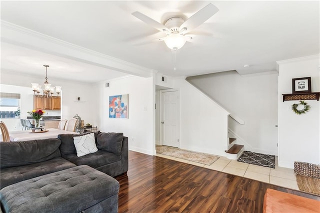 6720 Argonne Boulevard ., New Orleans, LA 70124 - living area with wood finished floors, stairway, baseboards, ceiling fan with notable chandelier, and ornamental molding