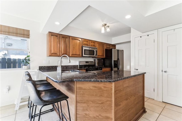6720 Argonne Boulevard ., New Orleans, LA 70124 - kitchen featuring a kitchen breakfast bar, visible vents, stainless steel microwave, freestanding refrigerator, and a peninsula