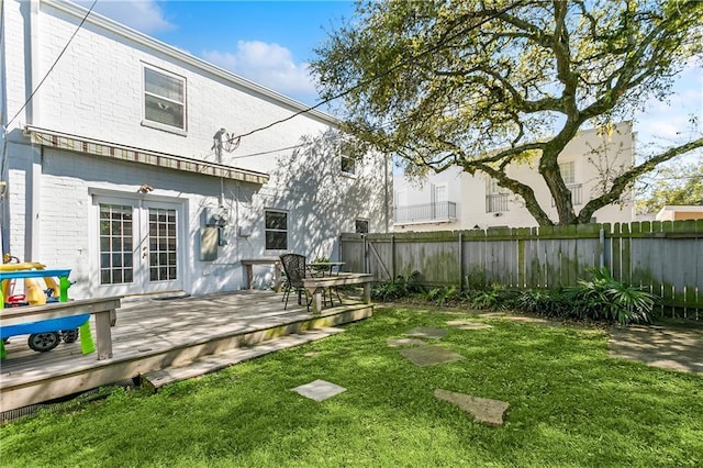 6720 Argonne Boulevard ., New Orleans, LA 70124 - rear view of property featuring fence, a wooden deck, a yard, and french doors