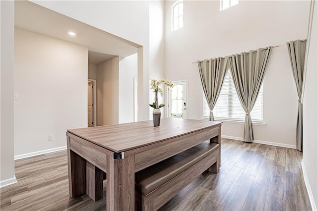 dining area featuring a wealth of natural light, baseboards, and light wood finished floors