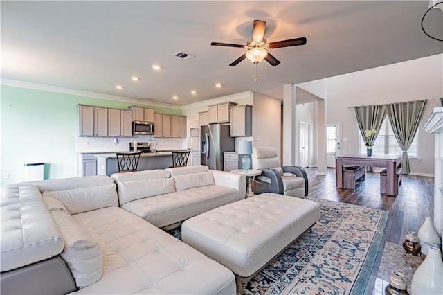 living area with visible vents, ornamental molding, recessed lighting, a ceiling fan, and wood-type flooring