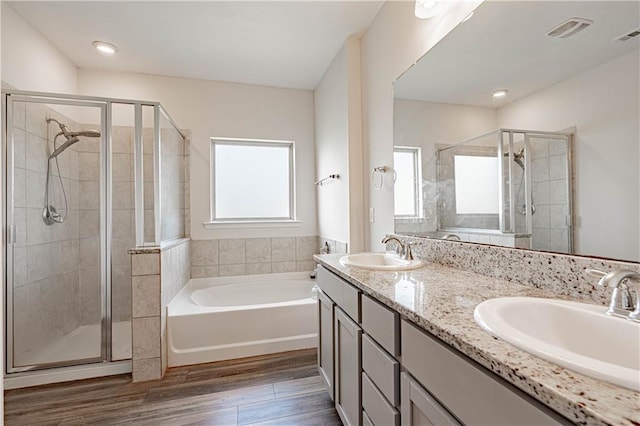 full bath with a sink, visible vents, and a shower stall