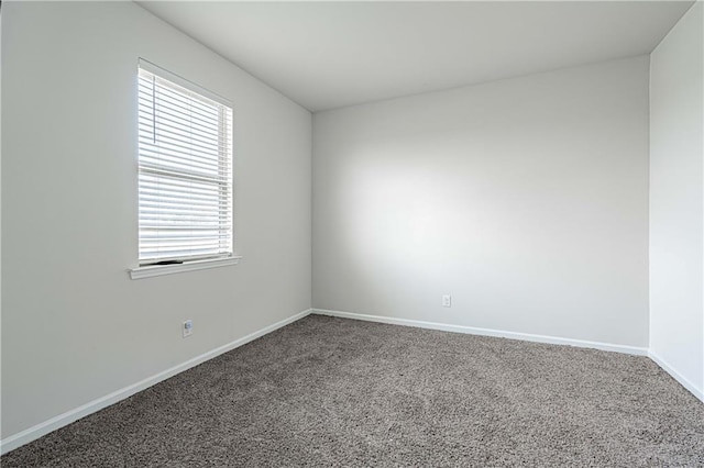 carpeted empty room with baseboards