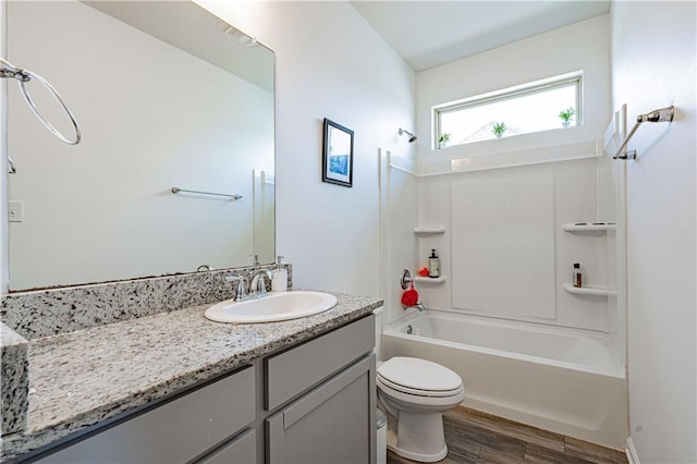 bathroom featuring shower / bath combination, toilet, wood finished floors, and vanity