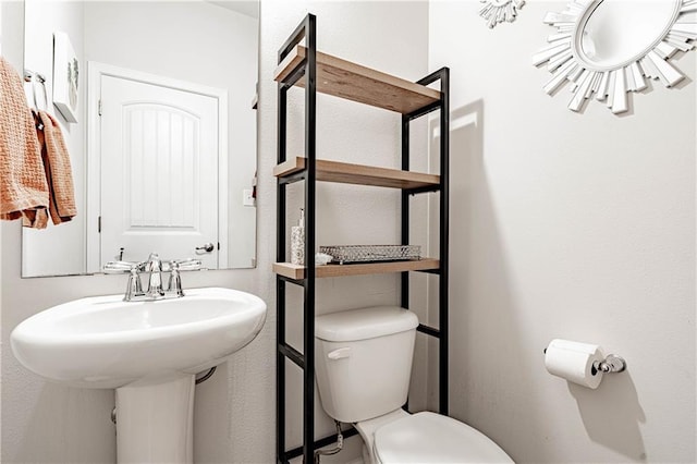 bathroom with toilet and a sink