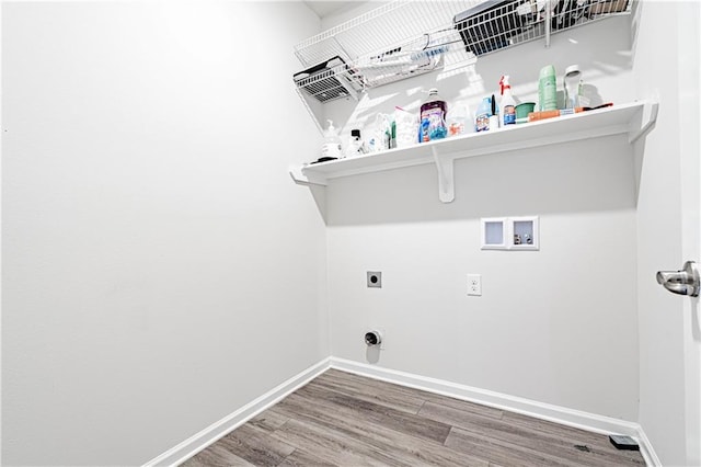 clothes washing area featuring baseboards, washer hookup, laundry area, wood finished floors, and electric dryer hookup