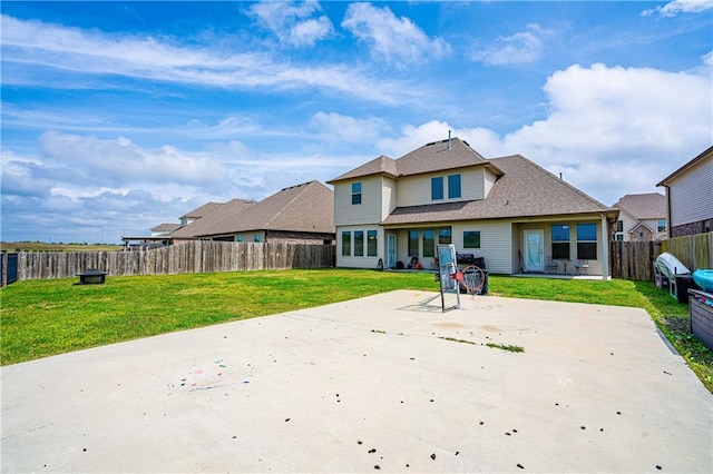 back of house featuring a patio, a lawn, and a fenced backyard