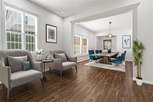 sitting room with baseboards and wood finished floors