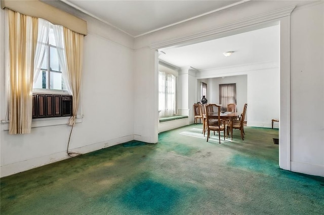 carpeted dining space featuring ornamental molding
