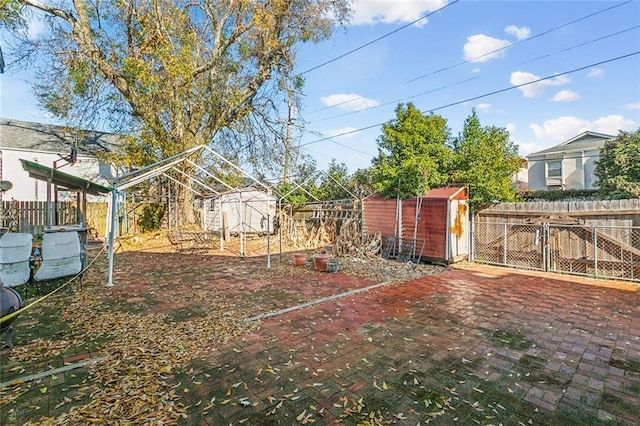 view of yard with a storage shed, a fenced backyard, and an outdoor structure