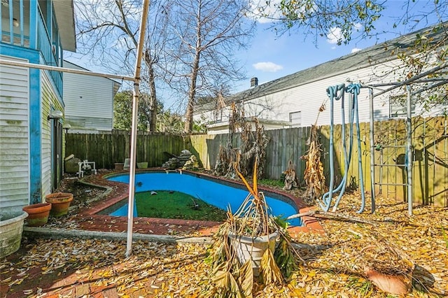 view of pool with a fenced backyard