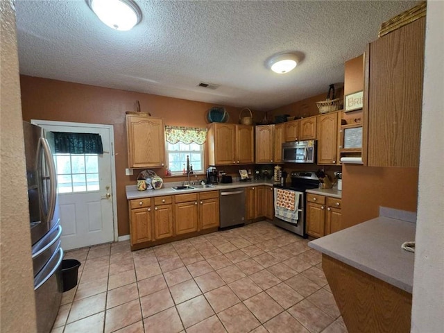 kitchen featuring a sink, light countertops, visible vents, and stainless steel appliances