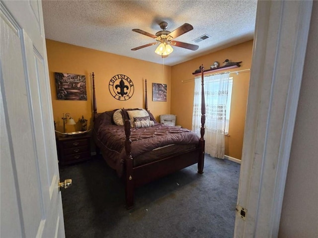 bedroom featuring carpet flooring, a ceiling fan, visible vents, and a textured ceiling