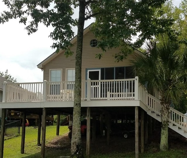 20996 Diversion Canal Rd, Saint Amant, LA 70774 - back of property featuring a deck, a carport, stairway, and a lawn