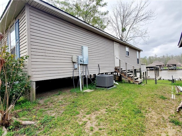 20996 Diversion Canal Rd, Saint Amant, LA 70774 - view of property exterior with entry steps, a lawn, and central AC