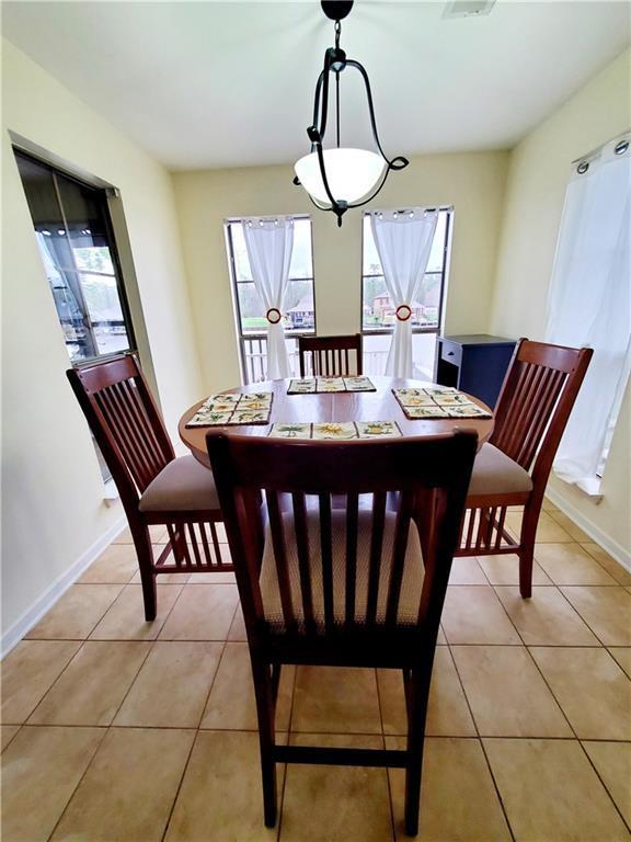 20996 Diversion Canal Rd, Saint Amant, LA 70774 - dining area featuring light tile patterned floors and baseboards