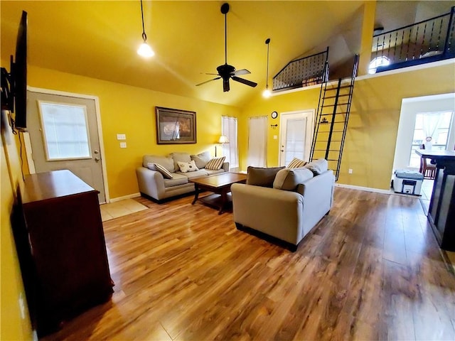 20996 Diversion Canal Rd, Saint Amant, LA 70774 - living room featuring high vaulted ceiling, wood finished floors, baseboards, and ceiling fan