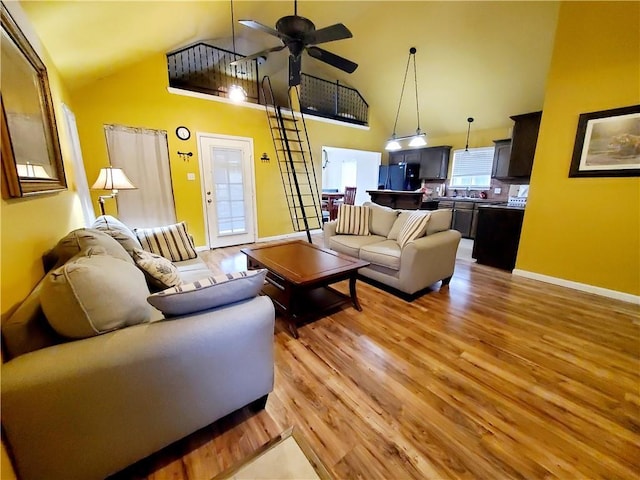 20996 Diversion Canal Rd, Saint Amant, LA 70774 - living room featuring baseboards, high vaulted ceiling, light wood-style floors, and ceiling fan