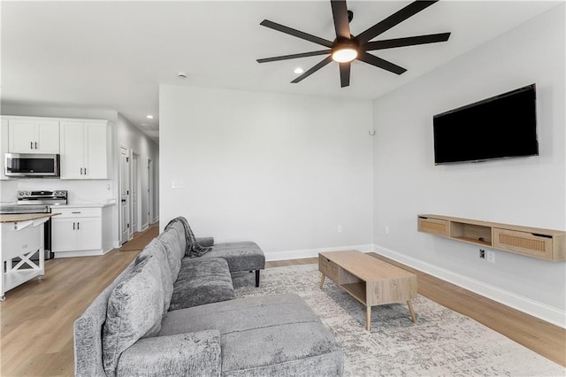 1413 Gordon St, New Orleans, LA 70117 - living room with ceiling fan, light wood-style flooring, recessed lighting, and baseboards