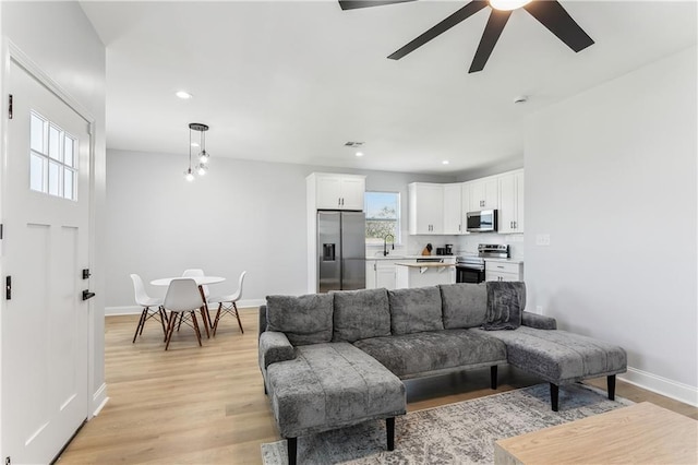 1413 Gordon St, New Orleans, LA 70117 - living area with a ceiling fan, light wood-style floors, baseboards, and recessed lighting