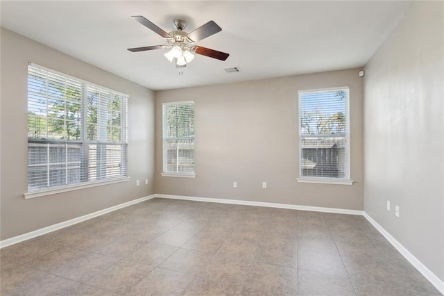 unfurnished room with tile patterned floors, baseboards, a ceiling fan, and visible vents