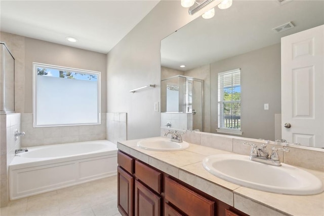 full bathroom with a shower stall, tile patterned floors, a sink, and visible vents