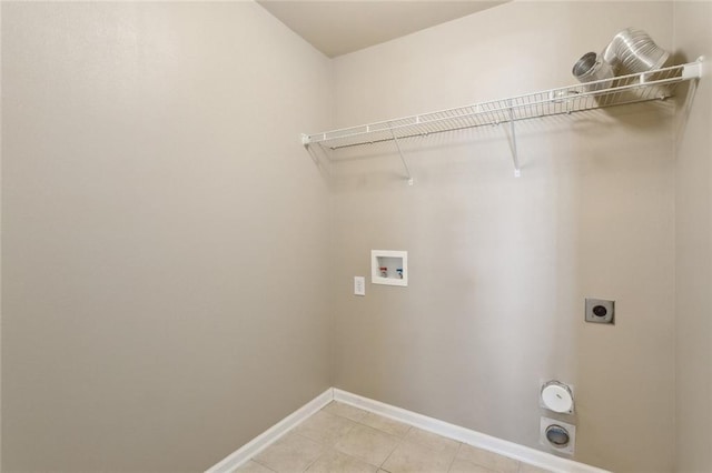 laundry area with laundry area, light tile patterned floors, hookup for a washing machine, electric dryer hookup, and baseboards