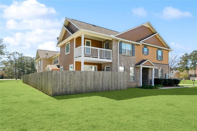 exterior space featuring fence and a lawn