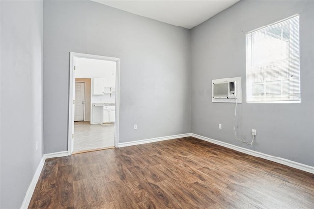320709 Bienville St, New Orleans, LA 70119 - spare room with a wall mounted air conditioner, baseboards, and wood finished floors