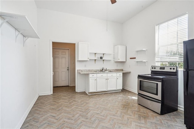 320709 Bienville St, New Orleans, LA 70119 - kitchen featuring white cabinetry, freestanding refrigerator, open shelves, stainless steel range with electric stovetop, and a sink