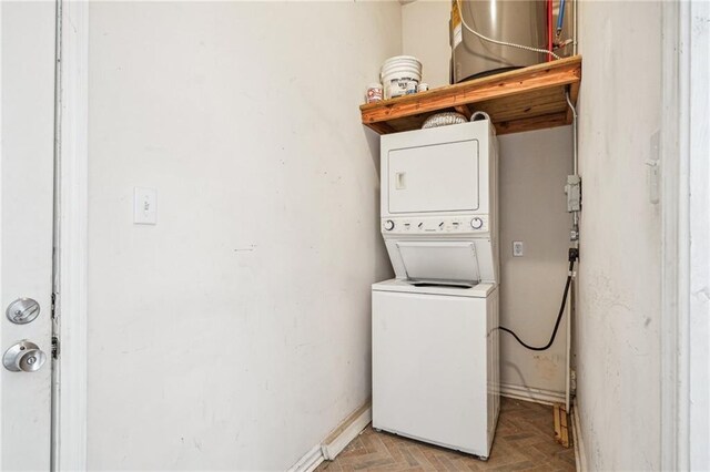 320709 Bienville St, New Orleans, LA 70119 - laundry room featuring stacked washing maching and dryer, baseboards, and laundry area
