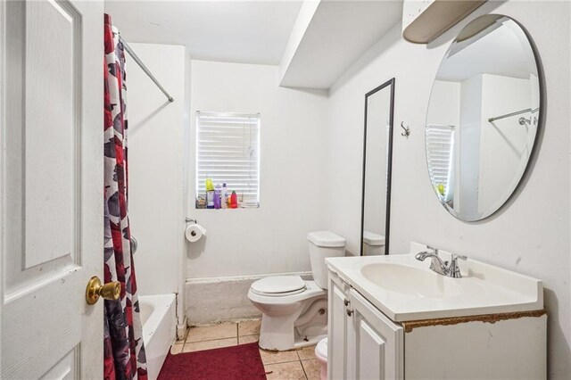 320709 Bienville St, New Orleans, LA 70119 - full bathroom with tile patterned floors, shower / tub combo with curtain, vanity, and toilet