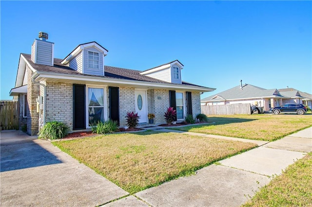 4504 Stella Dr, Meraux, LA 70075 - view of front of house with brick siding, a front yard, and fence