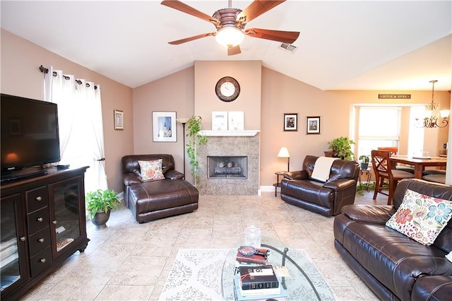 4504 Stella Dr, Meraux, LA 70075 - living room featuring visible vents, baseboards, a tiled fireplace, vaulted ceiling, and ceiling fan with notable chandelier