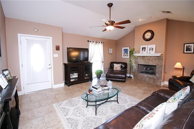 4504 Stella Dr, Meraux, LA 70075 - living area featuring visible vents, a tiled fireplace, baseboards, ceiling fan, and vaulted ceiling