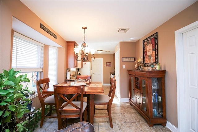 4504 Stella Dr, Meraux, LA 70075 - dining area with visible vents, baseboards, stone finish flooring, and an inviting chandelier