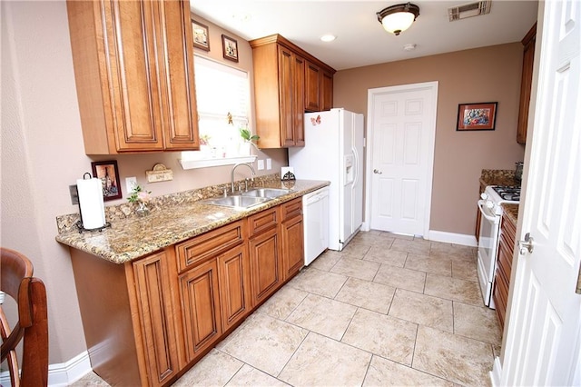 4504 Stella Dr, Meraux, LA 70075 - kitchen with brown cabinetry, visible vents, white appliances, and a sink
