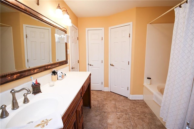4504 Stella Dr, Meraux, LA 70075 - full bathroom with tile patterned floors, vanity, baseboards, and shower / bath combo