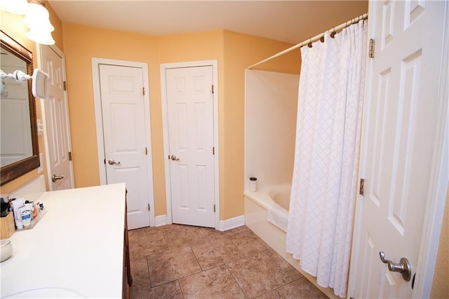 4504 Stella Dr, Meraux, LA 70075 - full bath featuring vanity, tile patterned floors, baseboards, and shower / tub combo with curtain
