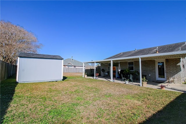 4504 Stella Dr, Meraux, LA 70075 - view of yard featuring a patio area, a storage shed, an outbuilding, and a fenced backyard