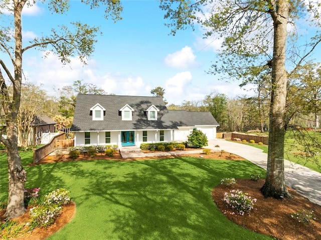 cape cod house featuring concrete driveway, an attached garage, and a shingled roof