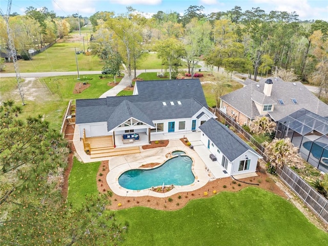 aerial view of property and surrounding area with a pool area